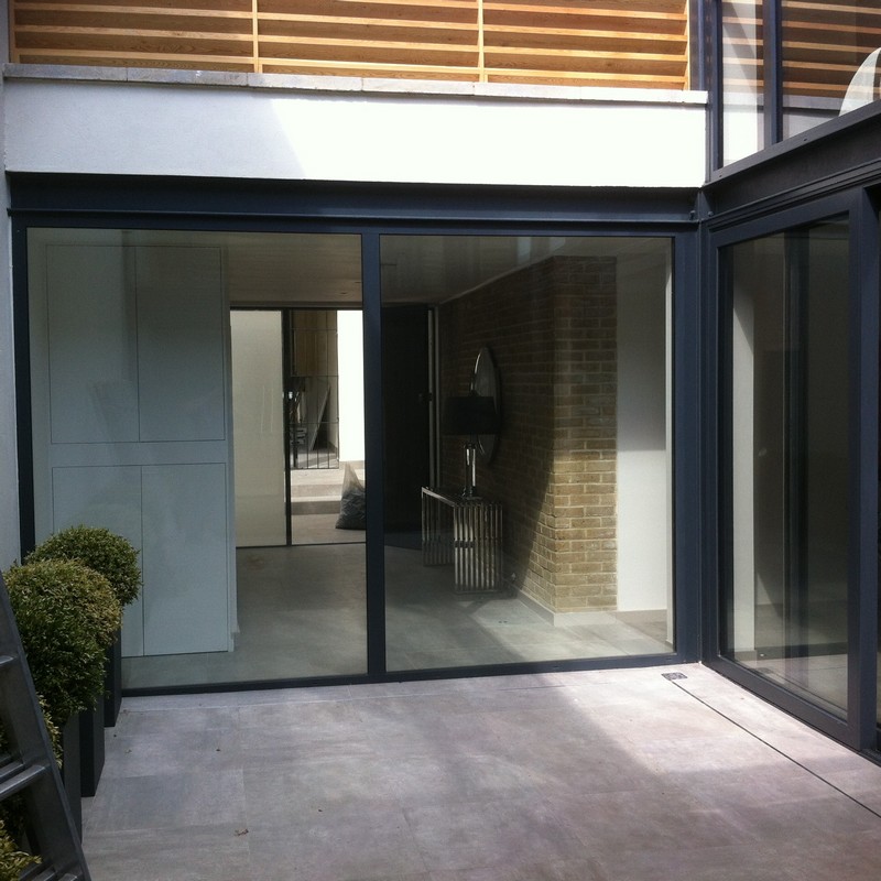 Floor-to-ceiling sliding doors opening to courtyard in Upper Edmonton