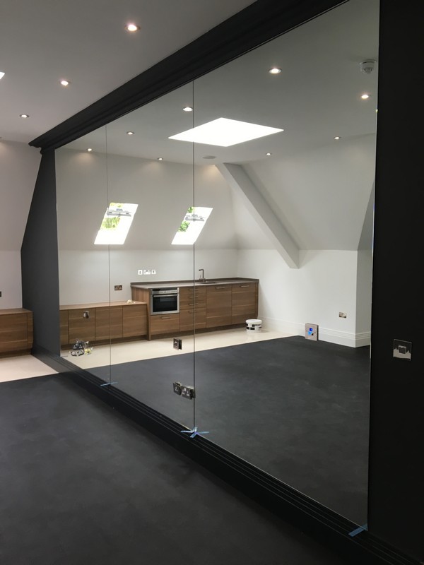 Frameless glass partition in loft conversion by Upper Edmonton glaziers
