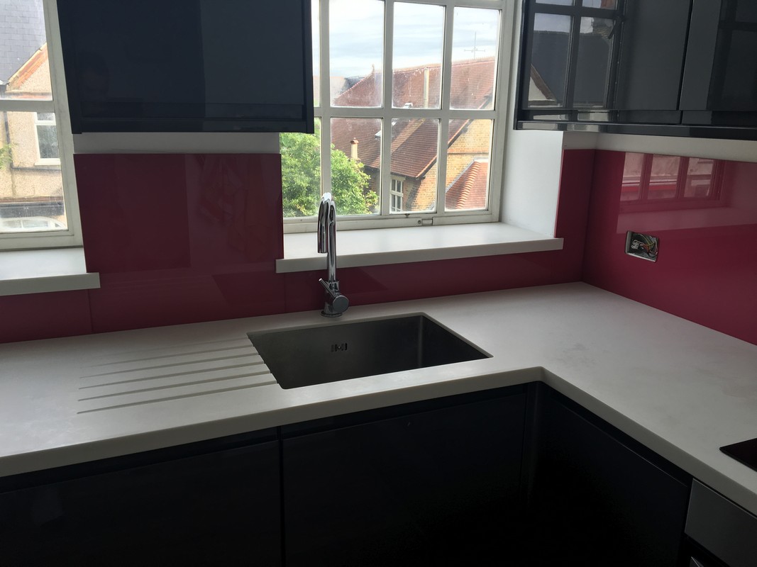 Deep plum coloured glass splashback in modern Upper Edmonton kitchen